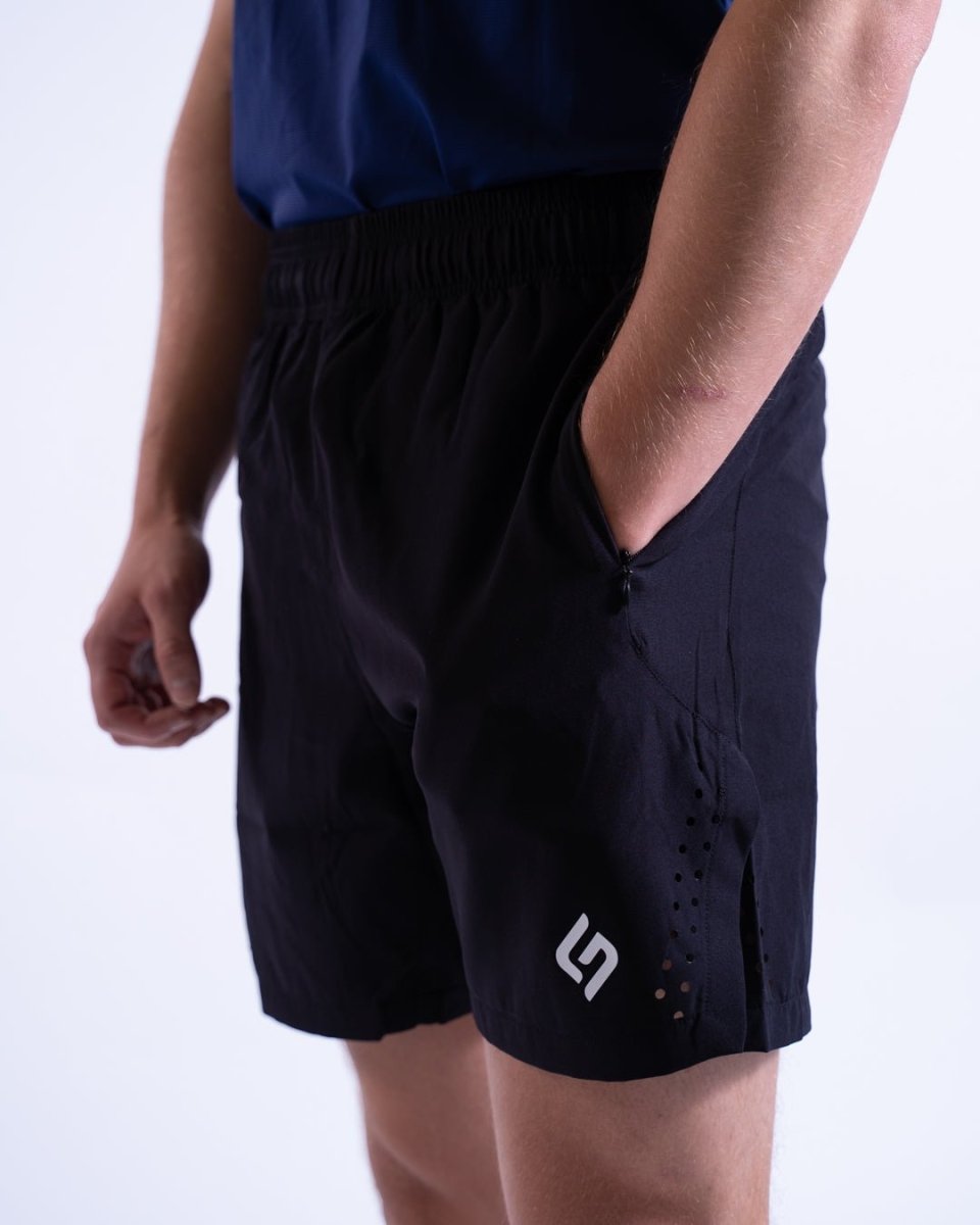 Close-up of zippered pocket on black shorts, showing secure storage for gym or workout essentials - Black - The Lasting Shape