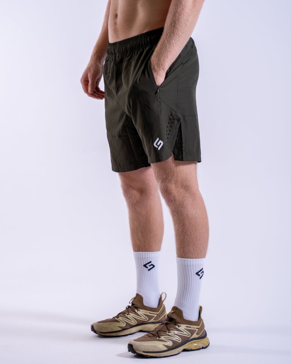 Side view of lightweight black men’s shorts, showcasing hand-in-pocket design for comfort and ease. Khaki - The Lasting Shape